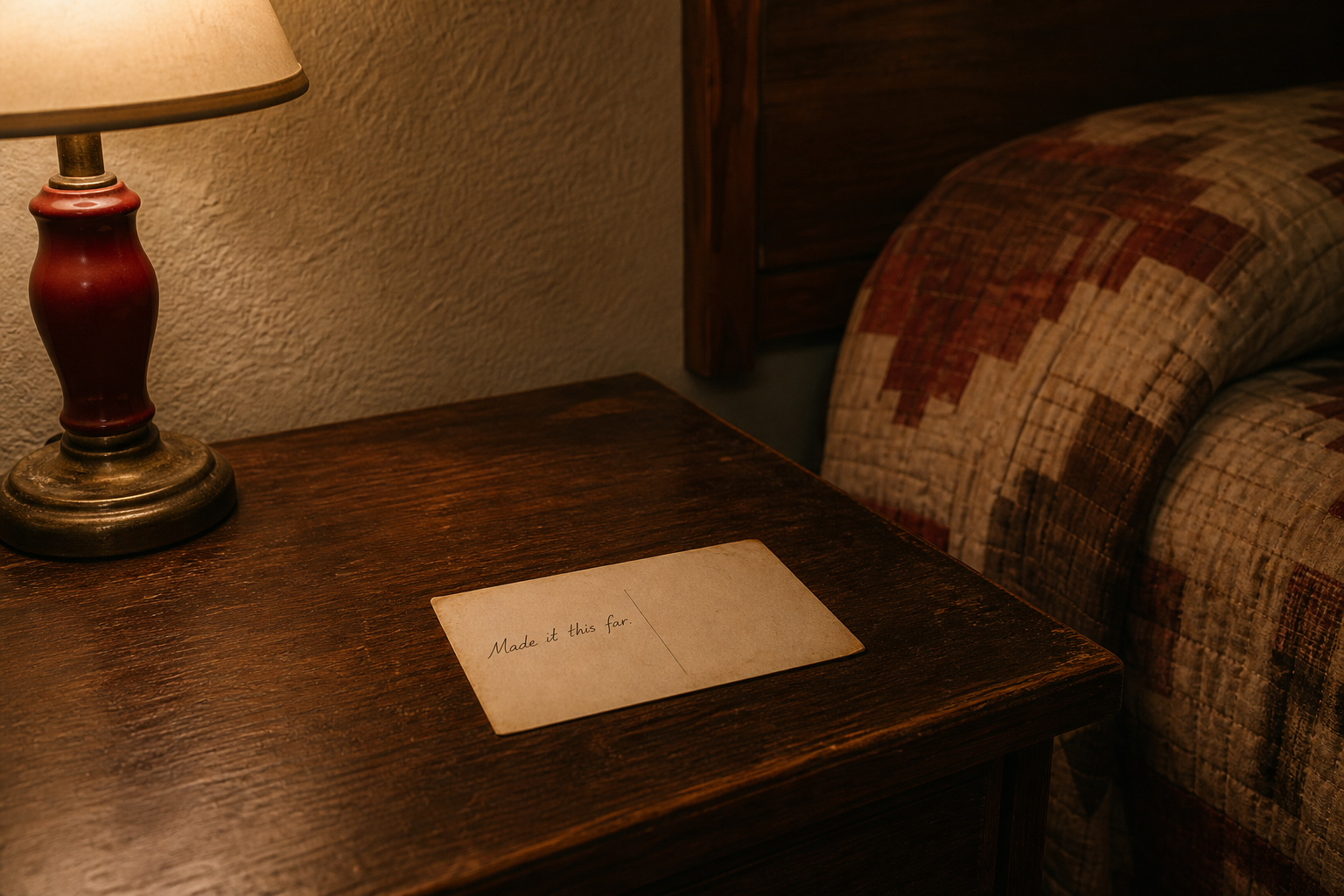 A postcard left on a wooden motel nightstand under warm lamp light